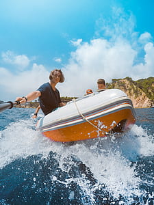 four people riding in inflatable raft during daytime thumbnail