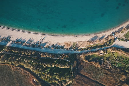 aerial photography of road beside body of water thumbnail