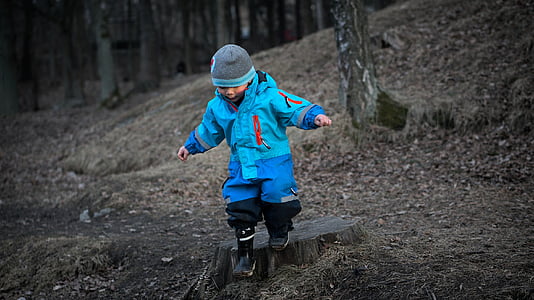 photo of boy walking on forest thumbnail