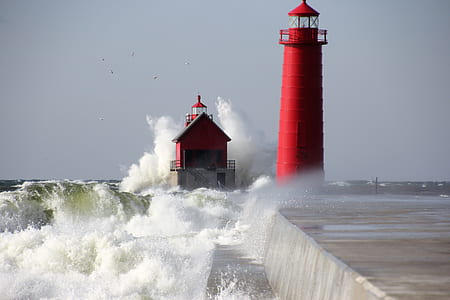time lapse photography of red lighthouse near body of water thumbnail