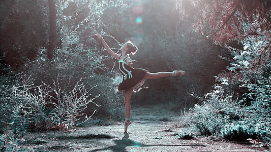 woman in black and white dress dancing in forest during daylight thumbnail