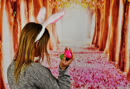 woman holding egg wearing bunny ear thumbnail
