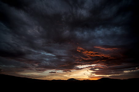 silhouette of mountains under white and grey cloudy sky thumbnail