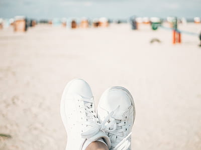 person wearing white sneakers thumbnail