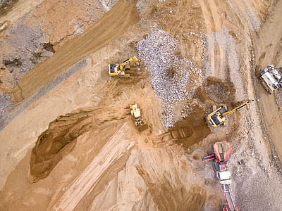 birds eye photography of heavy equipment on brown sand thumbnail