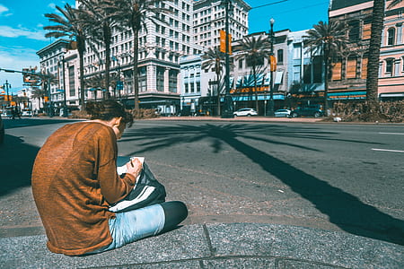 woman sitting on sidewalk thumbnail