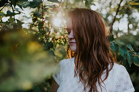 shallow focus photography of woman surrounded by trees thumbnail