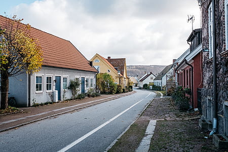 white and brown residential house near concrete road thumbnail