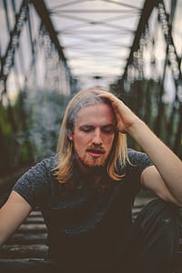 man smoking on metal bridge thumbnail