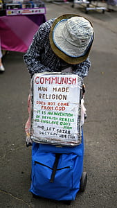 person wearing sun hot holding signboard thumbnail
