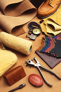 bullet hole puncher beside mat, watch, and wallet thumbnail