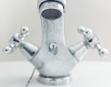 photo of water dropped from gray stainless steel faucet thumbnail