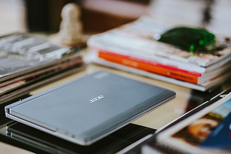 Laptop, a smartphone, magazines and cups of coffee on a table thumbnail