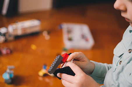 selective focus photography of toddler playing with building blocks toy thumbnail