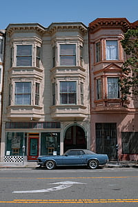 blue Ford Mustang coupe parking in-front of building during daytime thumbnail