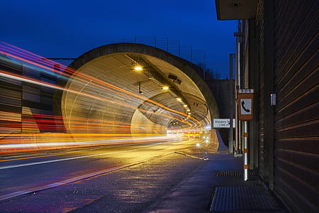 timelapse photography of speeding lights under road tunnel during nighttime thumbnail