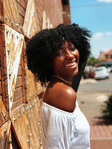 woman wearing white off-shoulder top smiling on camera thumbnail