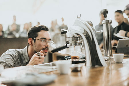 man in front of coffeemaker thumbnail