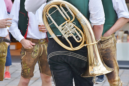 man holding wind instrument thumbnail