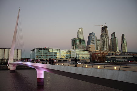 concrete wired bridge near buildings thumbnail