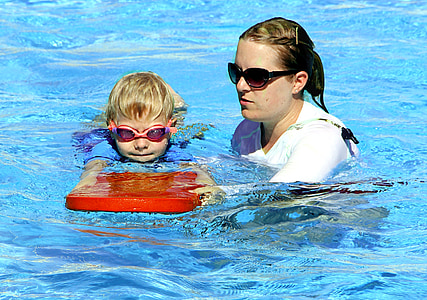 woman teaching boy to swim thumbnail