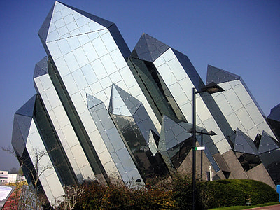 glass crystal-shaped building under blue sky at daytime thumbnail