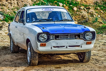 classic white and blue Ford Escort parked on ground during daytime thumbnail