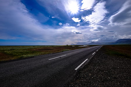 Concrete Road Between Grass Fields thumbnail