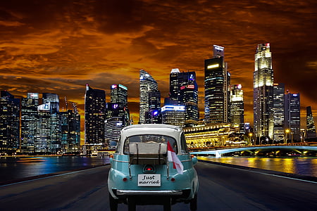 classic teal car near lighted high rise building during nighttime thumbnail