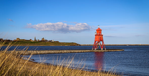 red lighthouse tower on dock during daytiome thumbnail