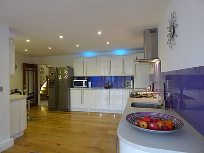 white kitchen cupboards beside black side by side refrigerator with dispenser thumbnail