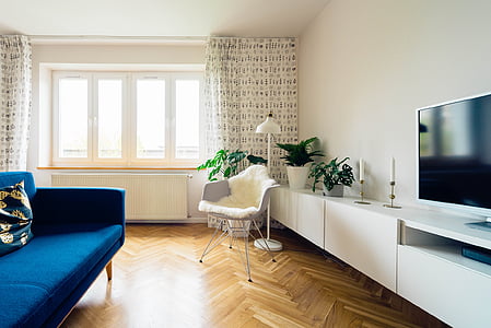 white chair near flat screen TV and window curtian thumbnail