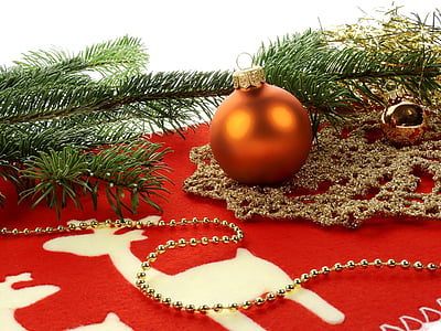 orange Christmas bauballs on red cloth thumbnail