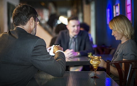 man sitting on chair beside table thumbnail