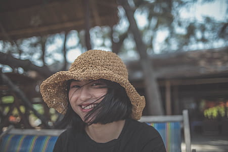 Woman With Brown Hat Sitting on Chair thumbnail
