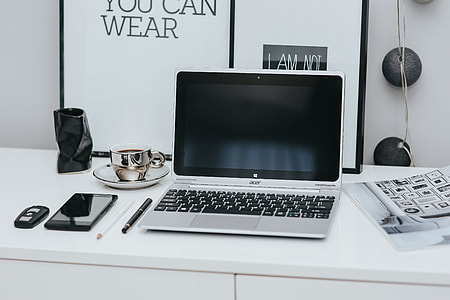 Laptop computer on white desk thumbnail