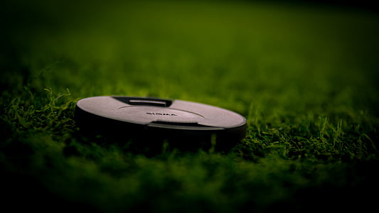 round black device on green grass thumbnail