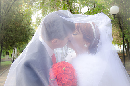 man and woman kissing white in veil thumbnail