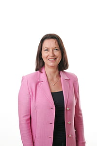 Smiling Woman Wearing Black Shirt and Pink Button Up Blazer thumbnail