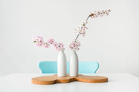 white and pink flowers on white ceramic vases thumbnail