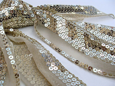 gold sequined scarf on white surface thumbnail
