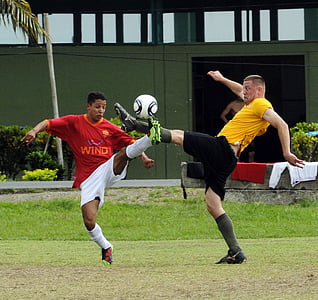 two men playing soccer during daytime thumbnail