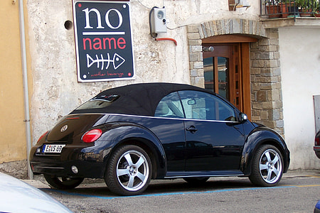 black Volkswagen New Beetle cabriolet park in front of no name signage thumbnail