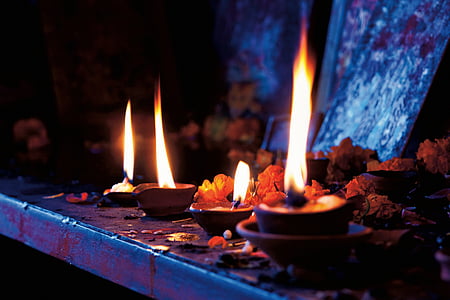 red candle lighted on table thumbnail
