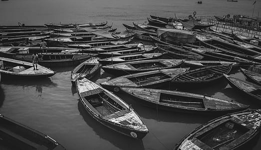 grayscale photography of canoe boats on body of water thumbnail