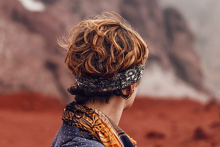 person wearing headband and facing at mountain thumbnail