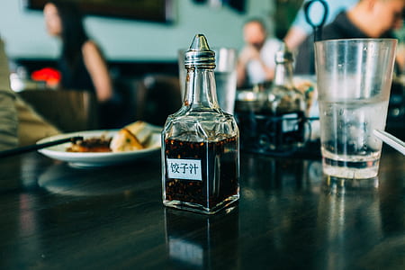 closeup photo of clear glass soy sauce cruet thumbnail