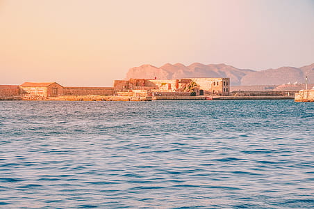 photo of beige building near body of water thumbnail