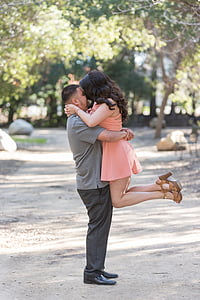 depth of field photography of man hugging the woman thumbnail