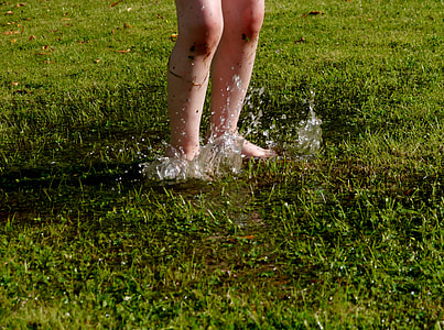 person standing on grass field with water thumbnail